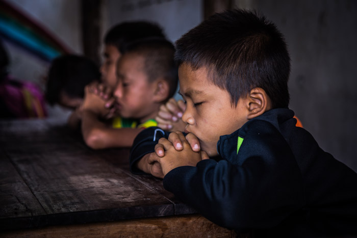 Boys praying in a church