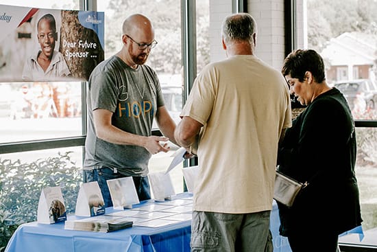 Compassion Sunday host helping at a table