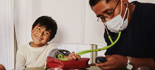 A boy having his blood pressure taken