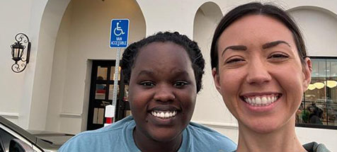 Two Compassion employees posing and smiling for a picture