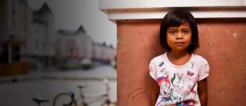 A young girl standing outside