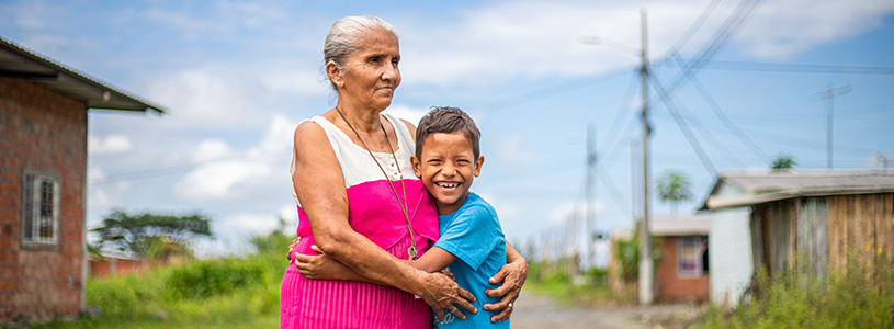 a grandmother hugs her grandson