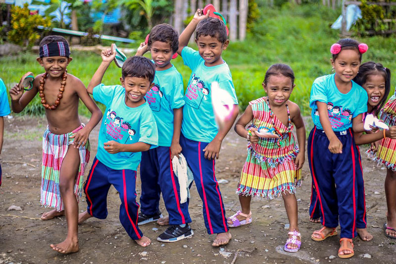 Children all laughing a playing a game