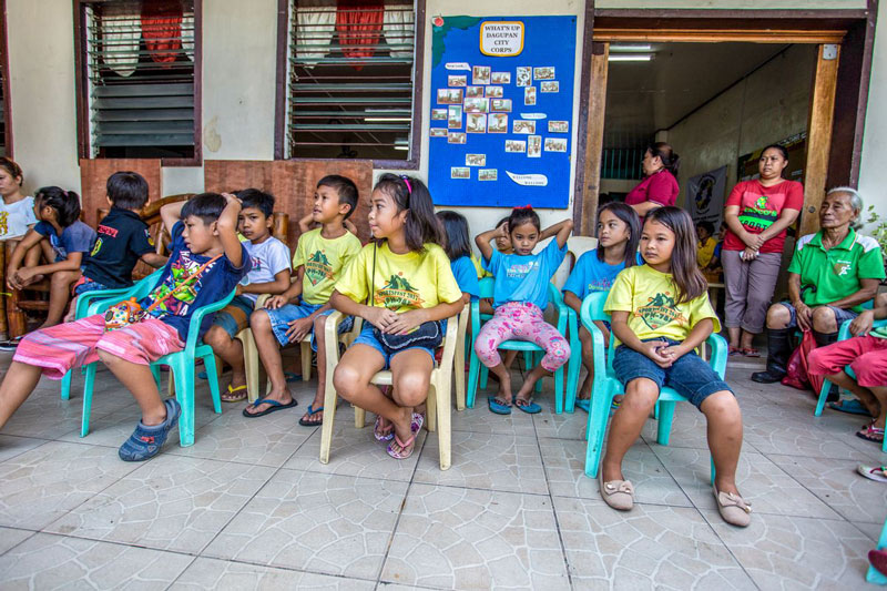 Kids sitting outside in chairs