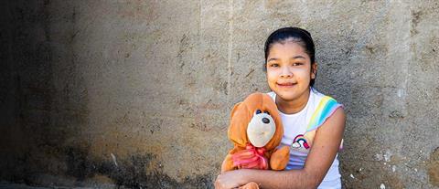 A girl holding a stuffed animal