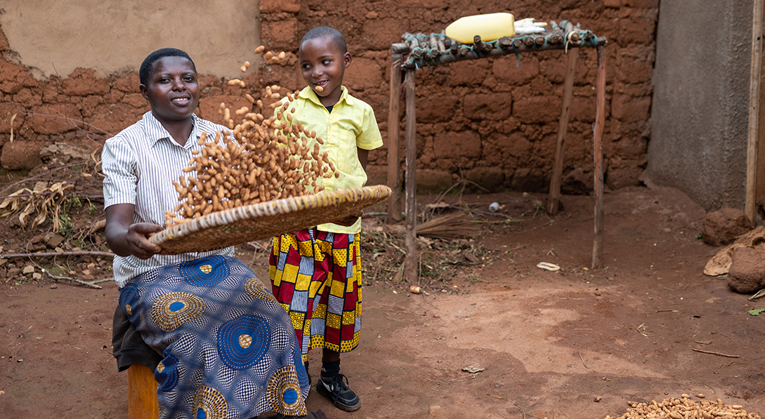 mother and son make food together outside their home