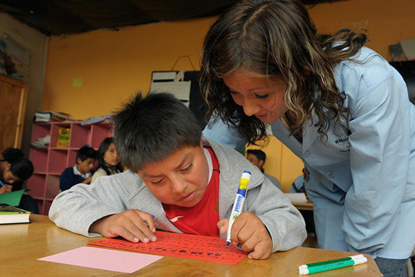 A teacher helps a student with special needs