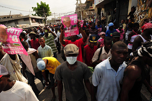 A group of people walking in the streets protesting for protection from conflict