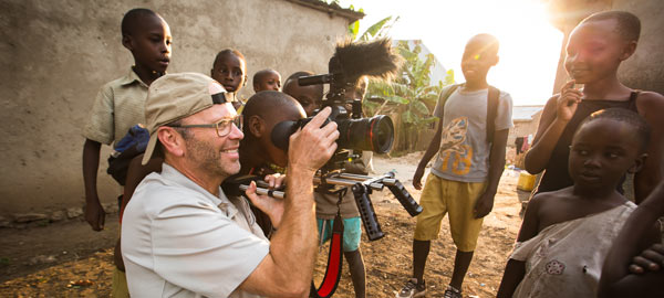 Children watching a Compassion photographer take pictures