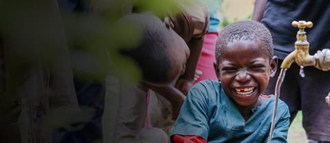 A Ugandan boy drinking clean water