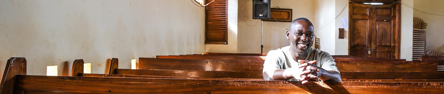 A man sits in a church pew