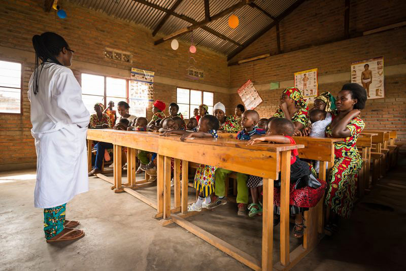 Children and their mothers attend class