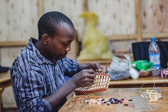 a boy doing beadwork