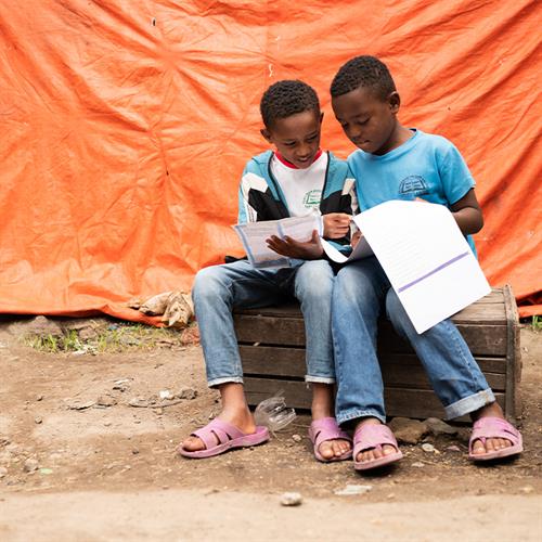 Boys read letter together