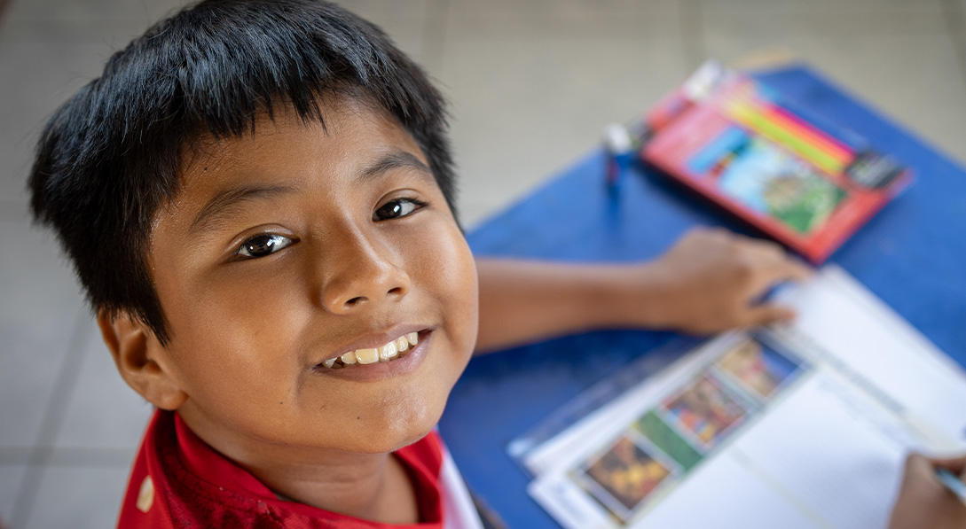 boy smiles with letter