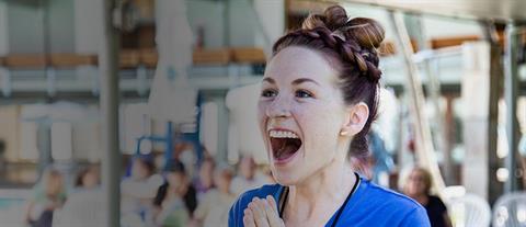 A young woman expressing excitement