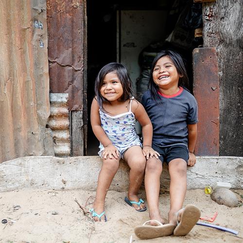 smiling children sitting on a step