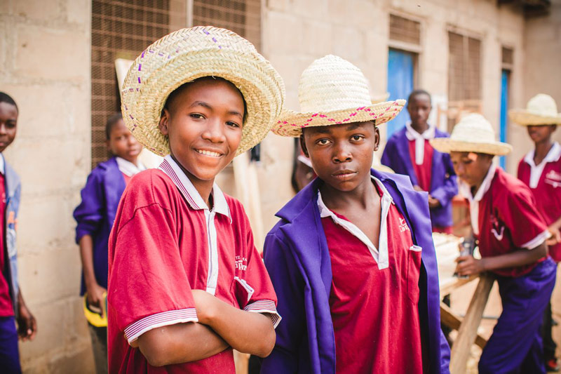 A group of boys wear hats while learning vocational skills at their child development center