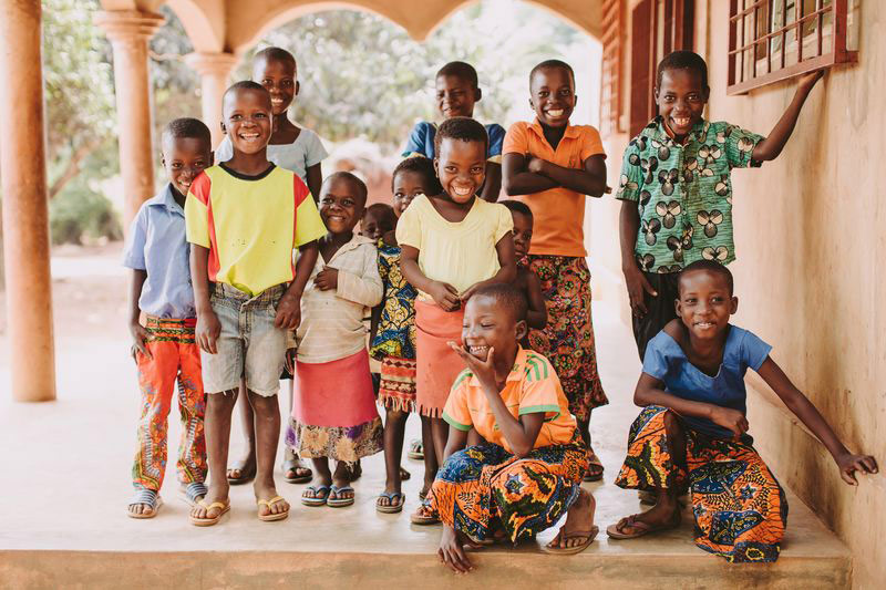 Children gather happily outside their child development center