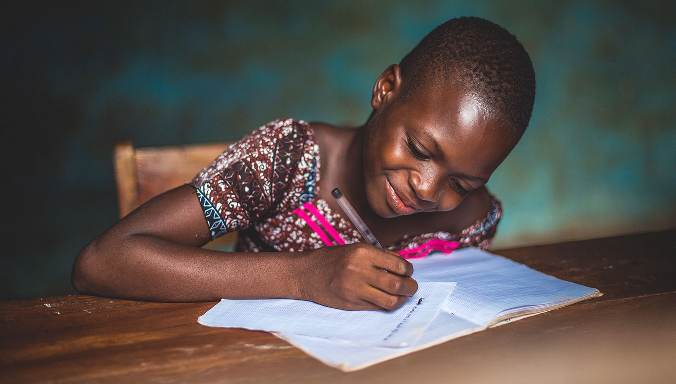 Ablavi writing a letter to her sponsors