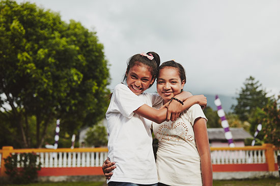 Two girls embracing and showing compassion