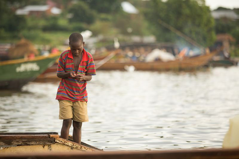 A boy stands near water