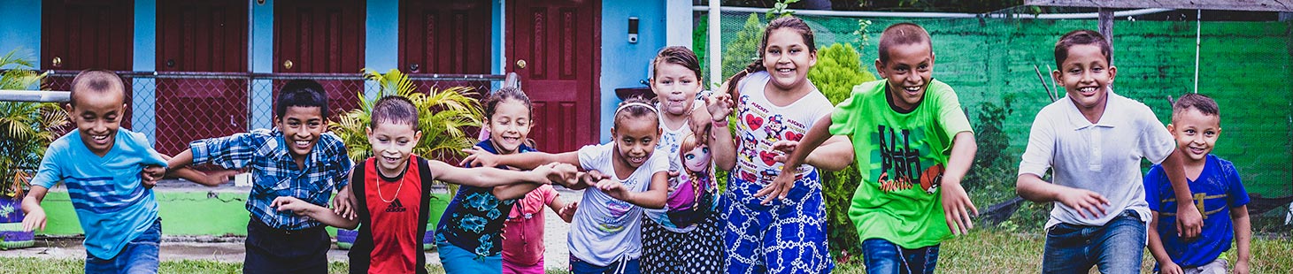 a group of children running and holding hands