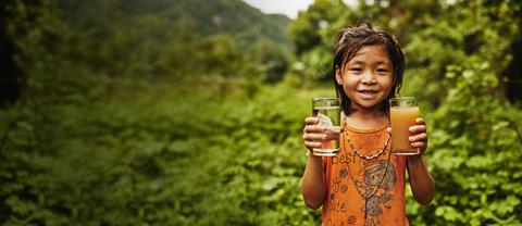 A girl holding a glass of water