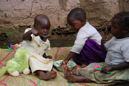 three toddlers eating