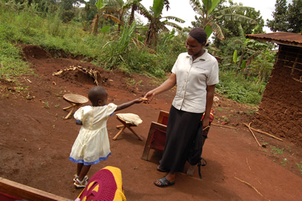 a young girls hands something to her mother