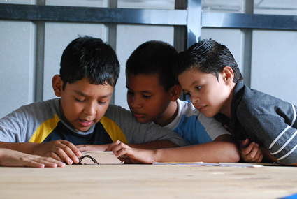 three boys read the bible together