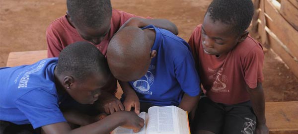 Children sitting and reading the bible