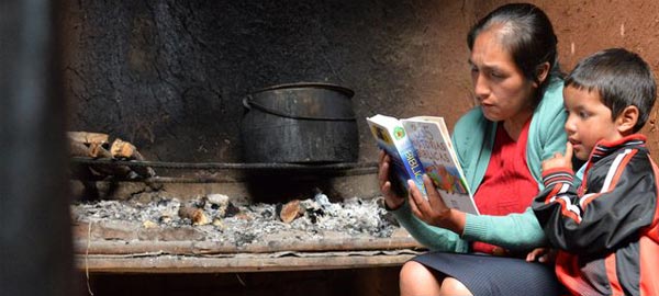 Mom reading the bible to child in poverty