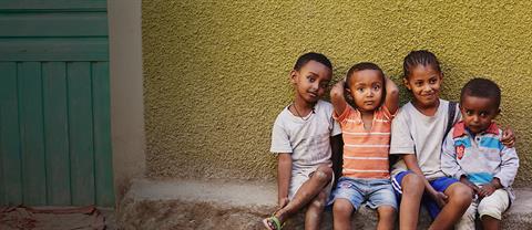 four children sitting outside