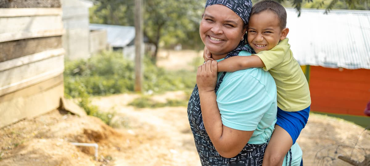 Woman carrying child on back