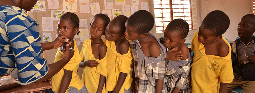 A line of children waiting to be vaccinated