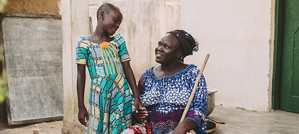 a woman sits with her granddaughter