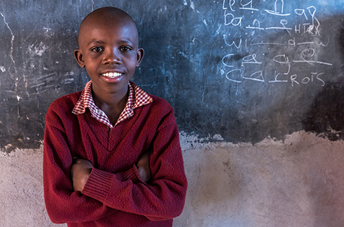 A student standing in front of a chalkboard