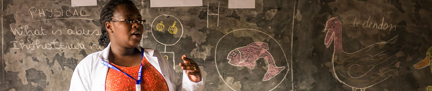 A teacher standing in front of a chalkboard