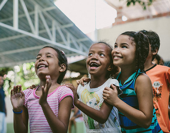 Three Brazilian girls excited to receive their sponsor letters