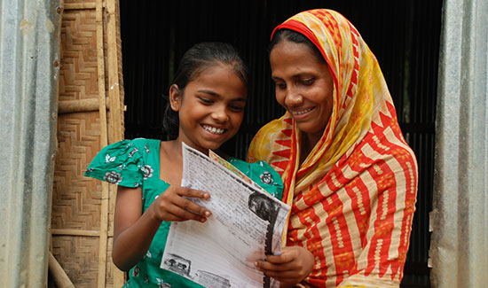 A daughter and mother read a letter together