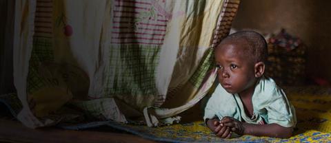 Young boy laying on blanket