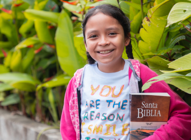 child holding a Bible