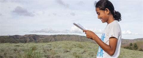 A girl holding her sponsor letter